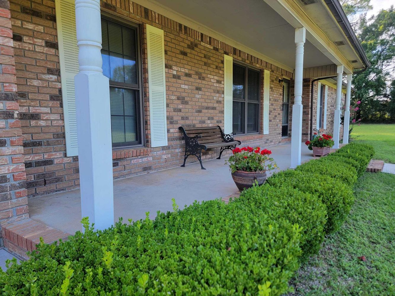 Brick home with a manicured lawn in Crestview, Florida
